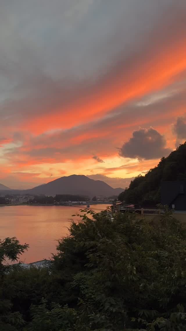 The sky whispers in hues of fire.
The lake listens, and so do you.